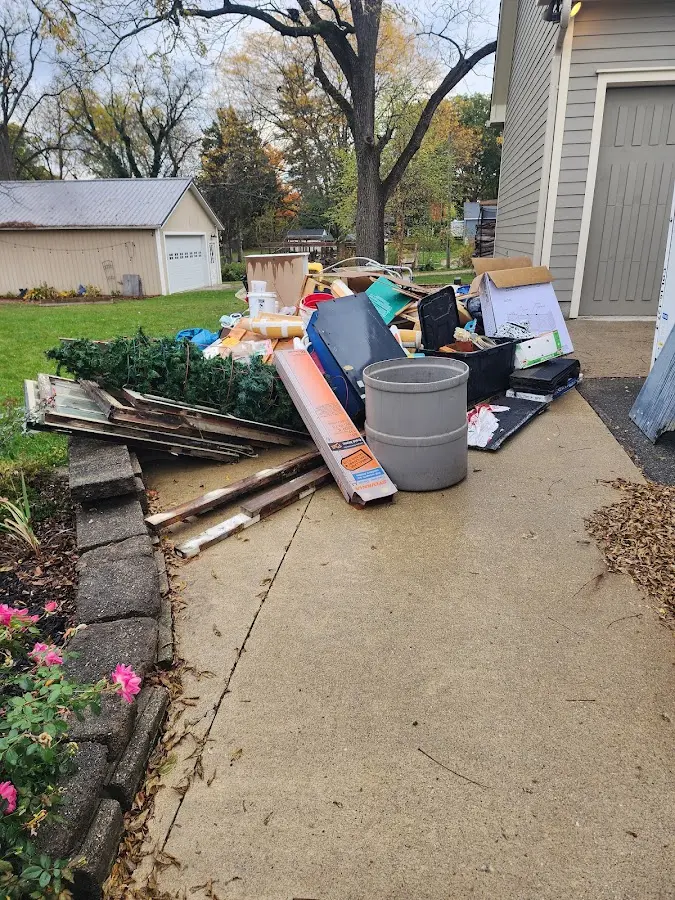 Dumpster being loaded with debris for Commercial Dumpster Rental in Cameron